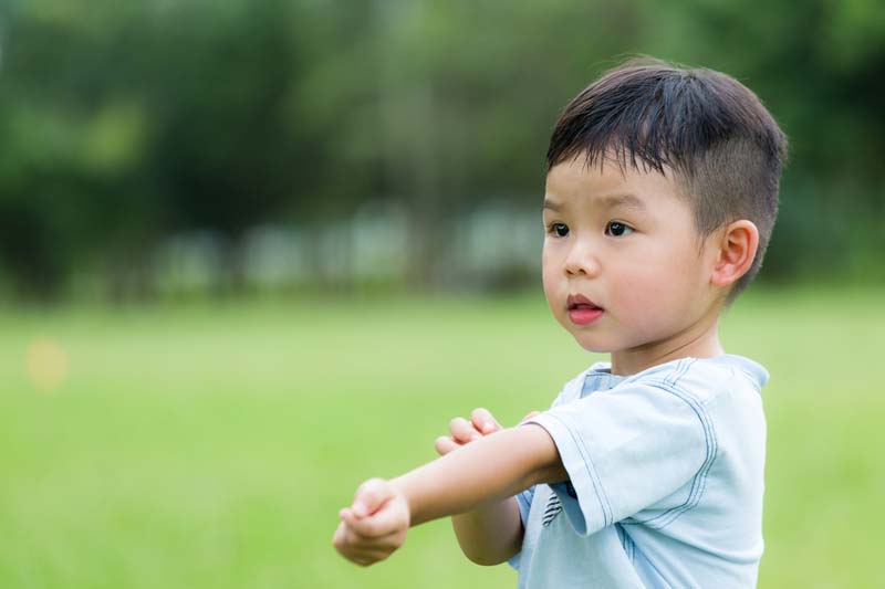 A boy scratching.